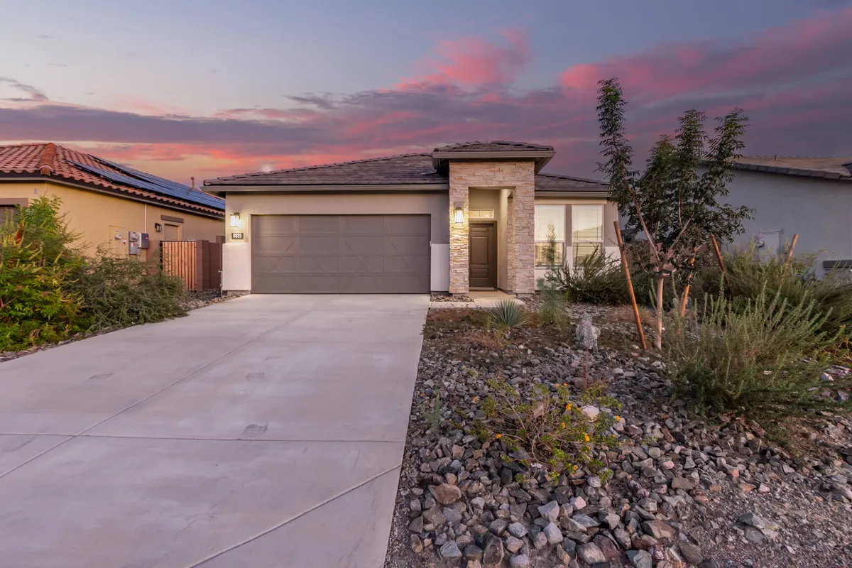 The exterior view highlights the modern architectural design of the home, including the front door, garage, and a serene atmosphere ideal for unwinding after lively sporting events.